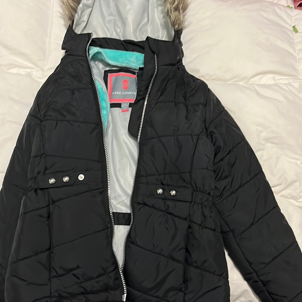 Size 10-12 girls black coat with teal lining. From free country. Warm and fuzzy